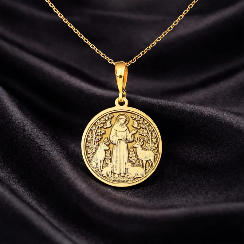 Luxe Amulet Saint Francis gold medallion on black fabric